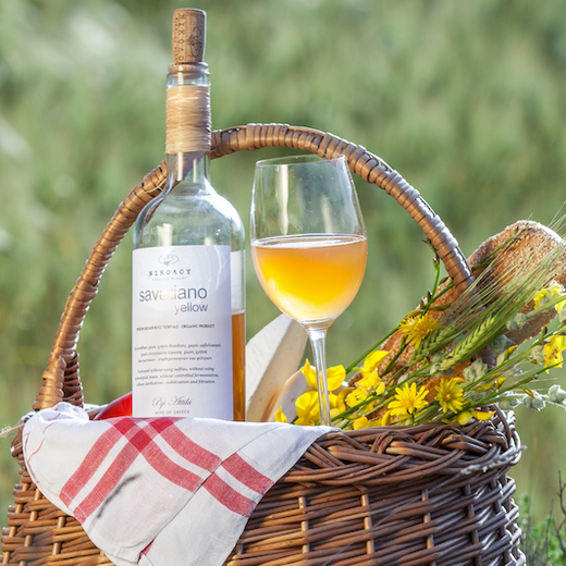 orange wine in picnic basket outdoors